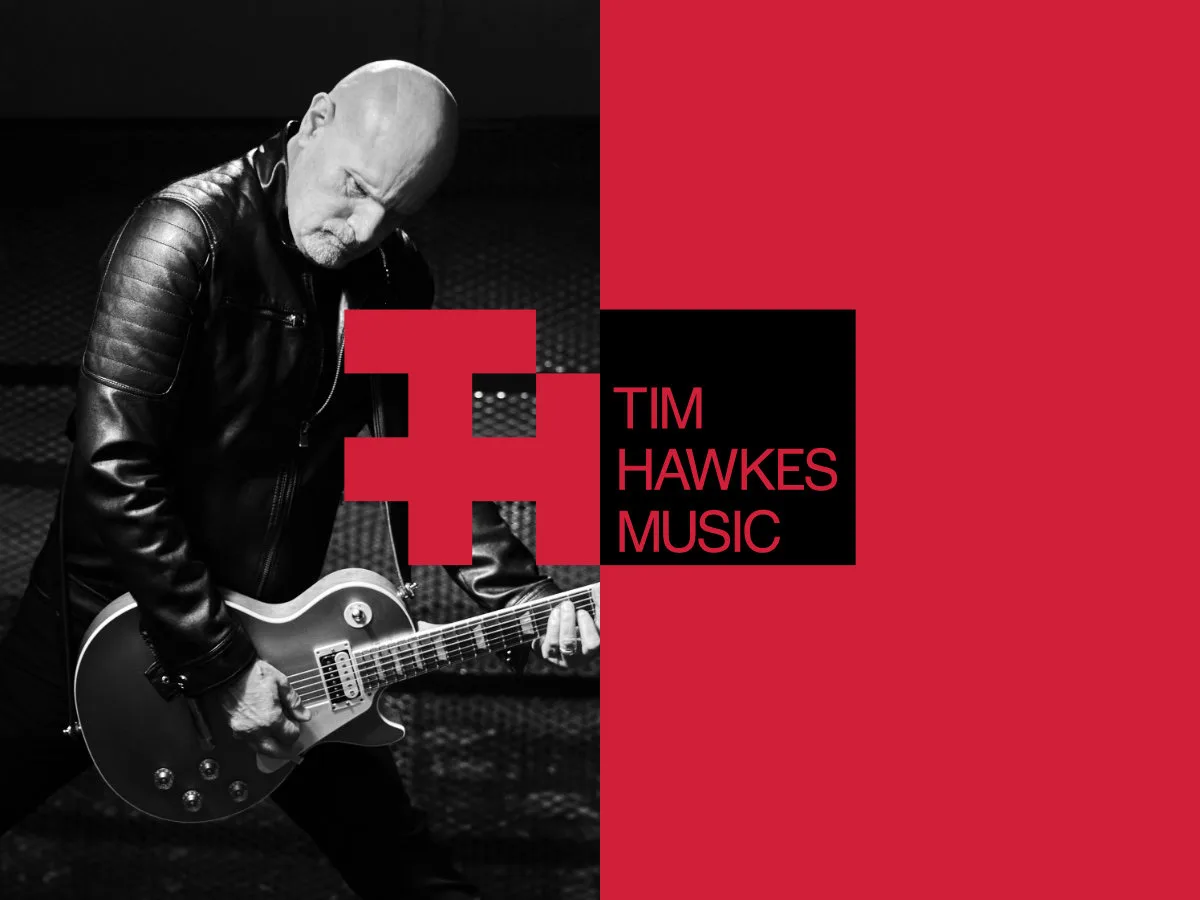 Image of Tim Hawkes playing guitar in black and white with the Tim Hawkes Music logo overlaid on top of it.