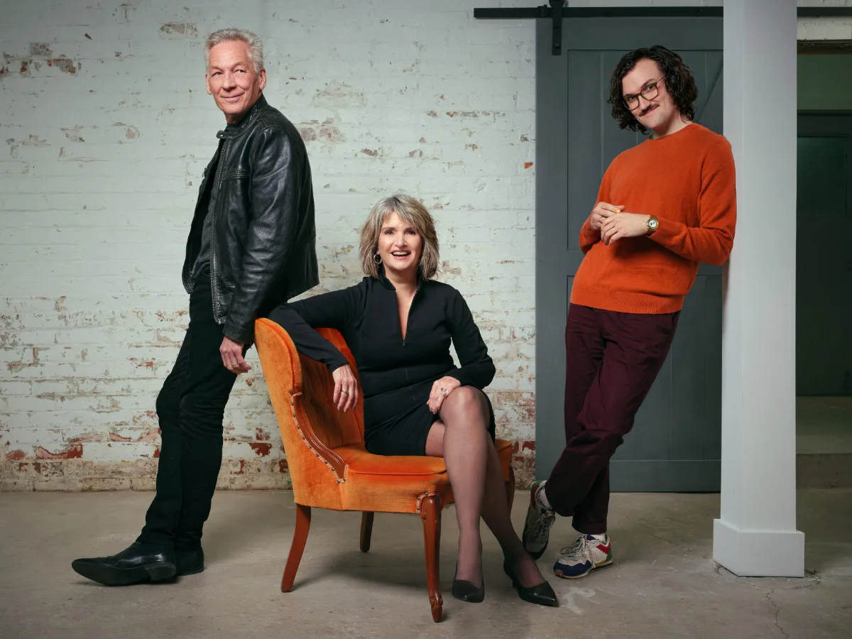 Photo of the Muse Marketing Group team, standing and sitting casually in a semi-candid pose with a distressed brick background. Featuring, from left to right, Mark Tharme, Judy Boswell and Simon Peng.