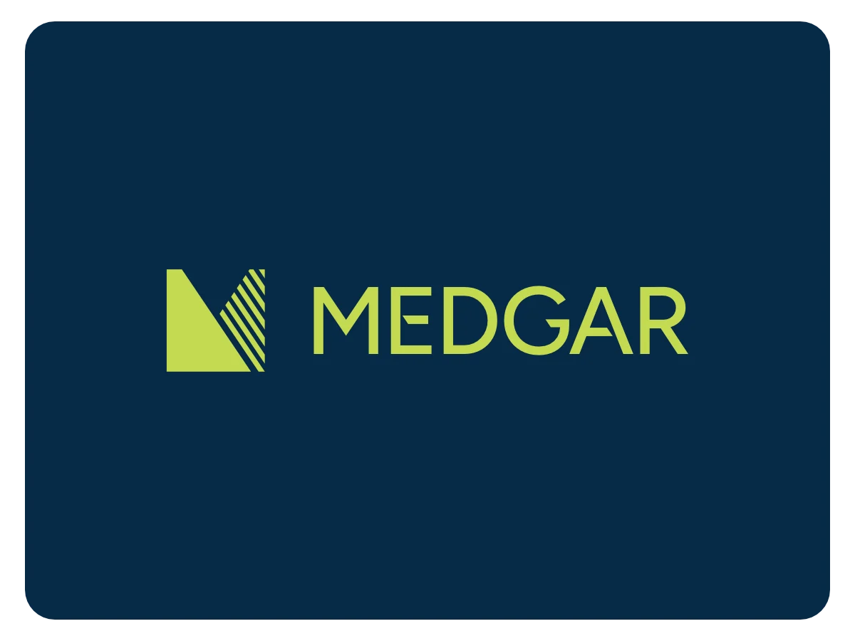 Image featuring the Medgar logo (an abstract M with a triangular shape on the left and a angled stripe pattern on the right next to the name "Medgar" set in uppercase letters) in green on a deep blue background.