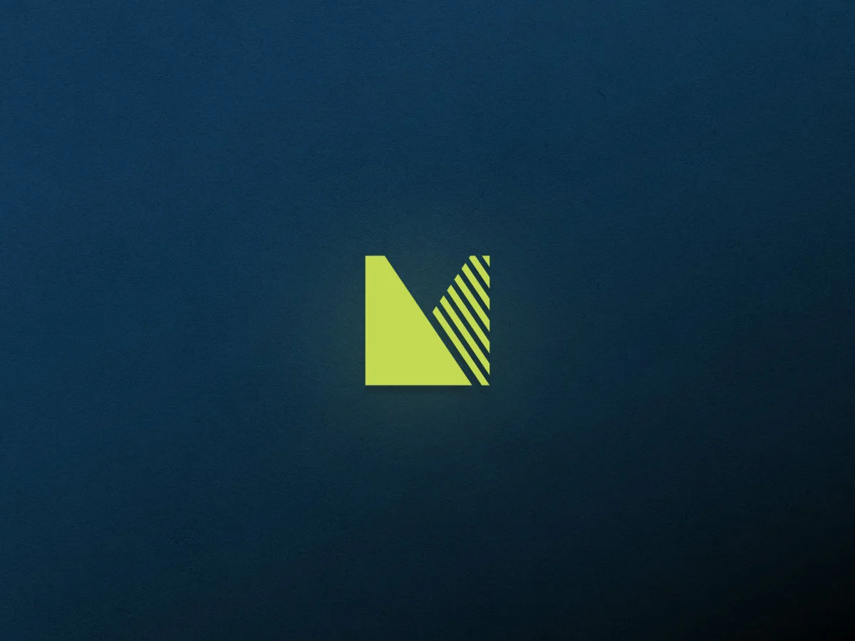 The Medgar icon on a dark blue background with a subtle gradient and texture.